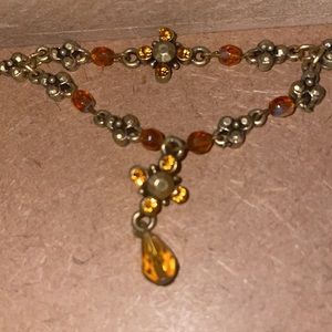 VINT AMBER STONE CHOKER WITH THE SAME STONES ALL AROUND IT AND BRASS CLOSURE